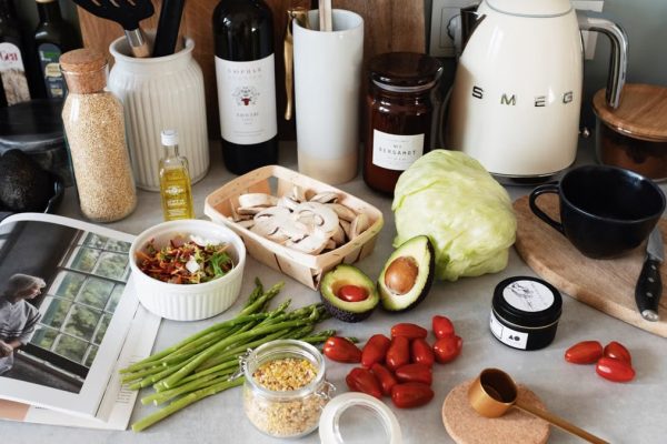 A variety of fresh ingredients and kitchen tools for preparing a healthy meal.